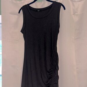 Simple black ribbed tank top dress with adjustable slit down the side.